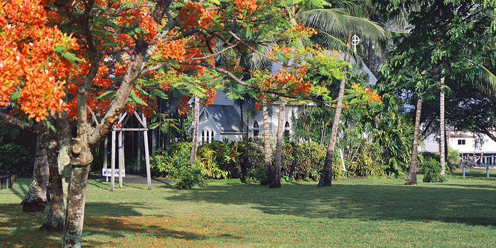 Port Douglas St Marys Church with flowering Poinciana tree